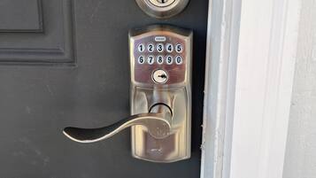 A door with a numeric keypad lock and a keyhole.