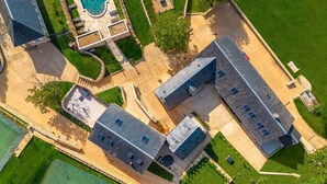 An aerial view of a residential area with a swimming pool, tennis court, and two main buildings with multiple windows. - Dordogne, Luxury Cottage, Domme and Sarlat, Hamlet Château Giverzac, With Airco (Domme)