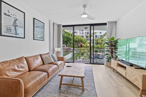Two-Bedroom Deluxe Apartment with Balcony | Living area | 55-cm Smart TV with digital channels, Netflix, streaming services - Swell Apartments - by Burleigh Letting (Burleigh Heads)