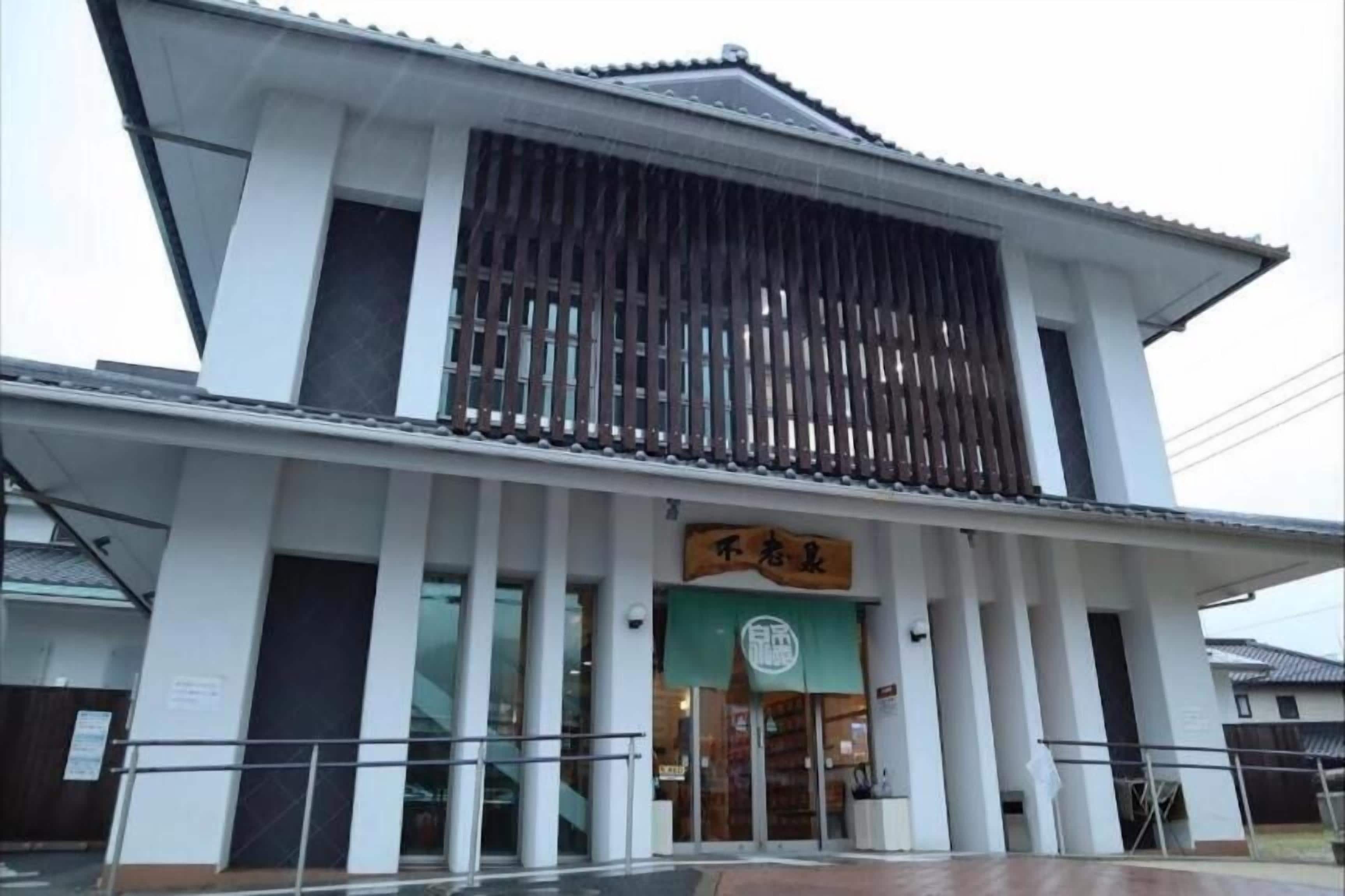 A building with a traditional architectural style, featuring a large entrance with a sign above the door.
