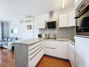 Fridge, dishwasher, coffee/tea maker, cookware/dishes/utensils