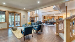 A spacious living area with a fireplace, a dining area, and a kitchen.