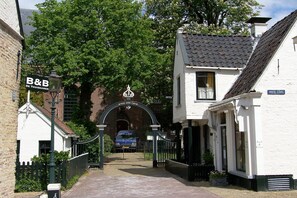 Step into the charming Ritsche Good Fruit B&B, nestled along a picturesque street lined with lush greenery.