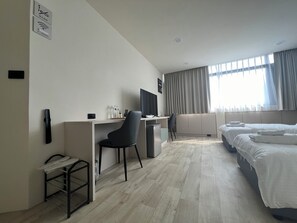 A modern hotel room with a desk, chair, and a bed. - CHIPP PLACE 2 (Zhudong)