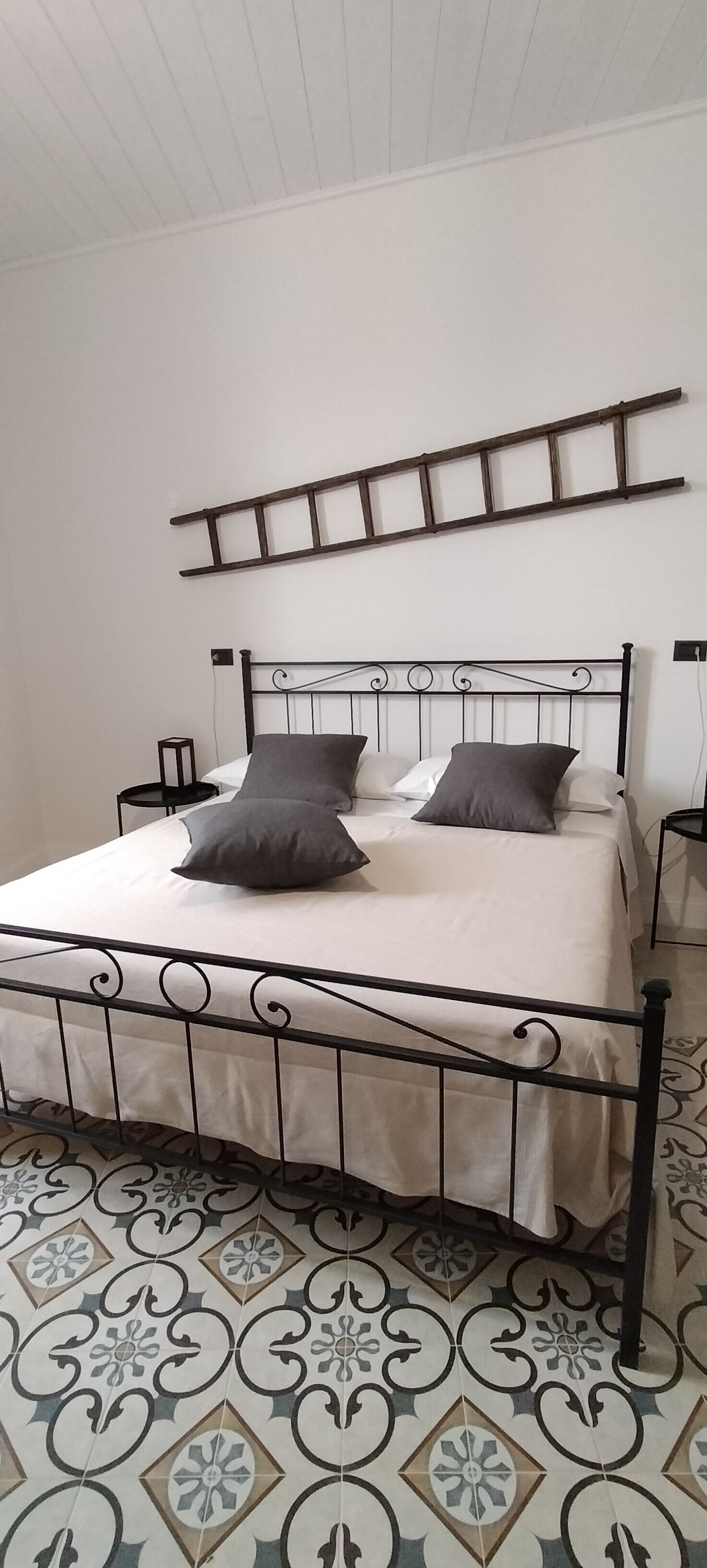 A bed with a metal frame, two pillows, and a white mattress.