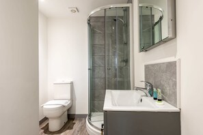 Shower, hair dryer, towels, shampoo