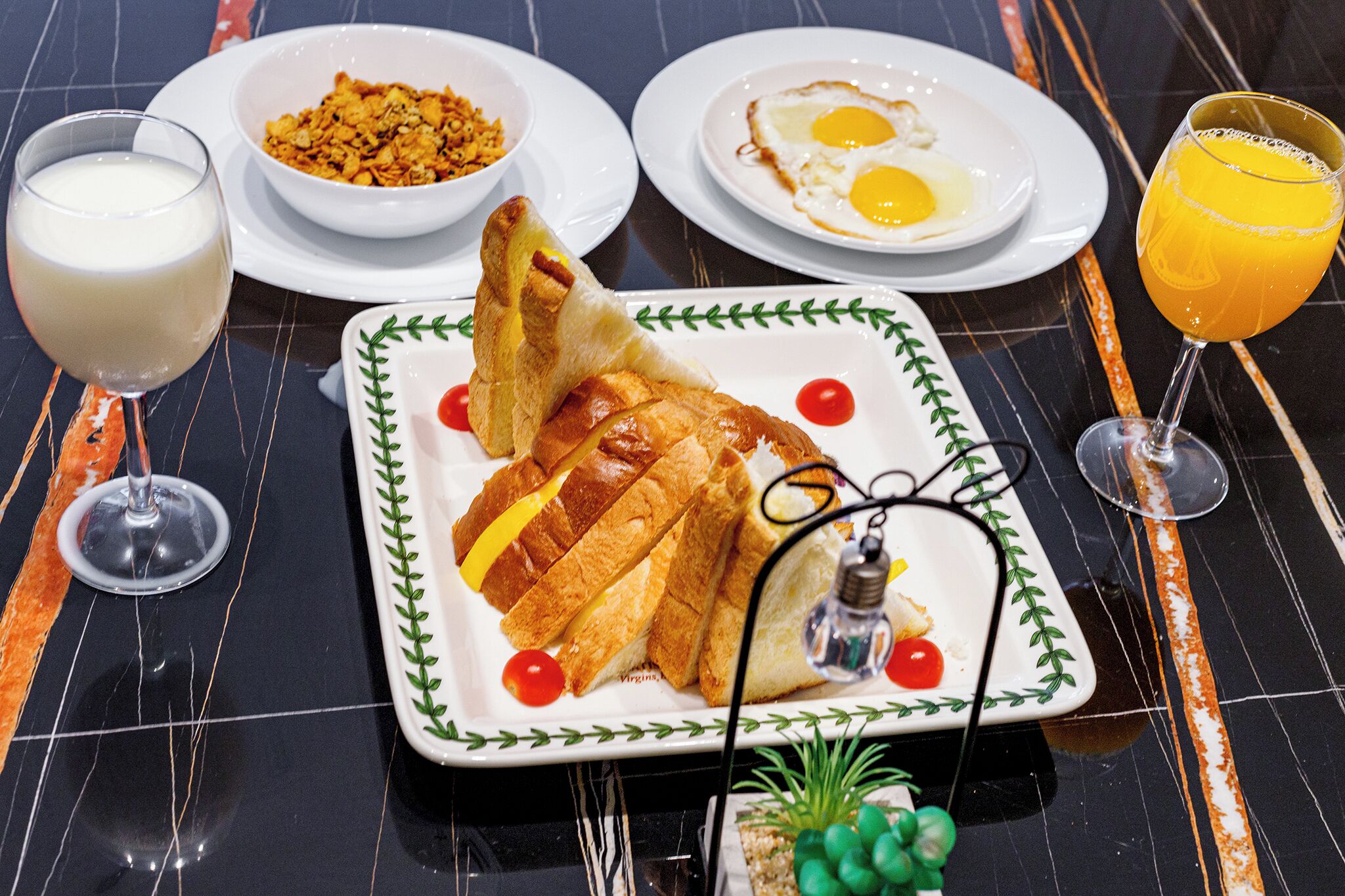 A breakfast setting with a plate of toast, eggs, and a glass of orange juice.