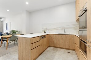 Two Bedroom Apartment with Parking | Private kitchen | Coffee/tea maker, toaster, dining tables - Hobson Quay Apartments by Urban Rest (Auckland)