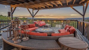An outdoor deck with a fire pit, wicker furniture, and a view of the landscape. - Indoor heated pool minutes to downtown Santa Fe (Santa Fe)