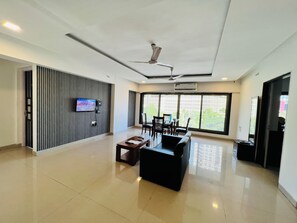 Deluxe Apartment, Balcony, City View | Living area | Flat-screen TV