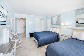 A hotel room with two beds, a chair, a desk, and a television. - Oceanfront Studio - Indoor Pools, Hot Tubs, Nice! (Myrtle Beach)
