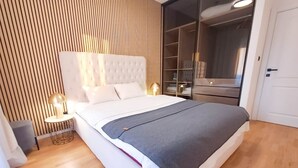 A modern bedroom with a large bed, a nightstand, a lamp, and a wardrobe. - Lovely Apartment at CITY QUART (Podgorica)
