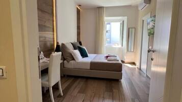 A modern bedroom with a bed, bedside table, and a chair.