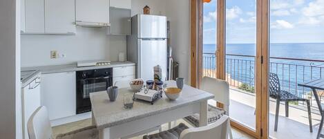 Basic Apartment, Sea View | Private kitchen | Full-size fridge, microwave, oven, stovetop