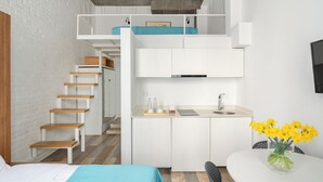 A compact, modern apartment with a loft bedroom, a kitchenette, and a dining area. - Mariinsky Boutique Hotel (Batumi)