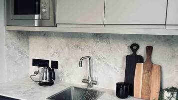 Fridge, microwave, stovetop, coffee/tea maker