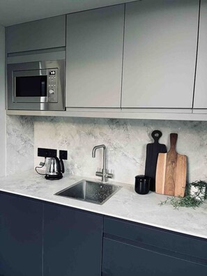 Fridge, microwave, stovetop, coffee/tea maker