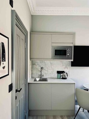 Fridge, microwave, stovetop, coffee/tea maker