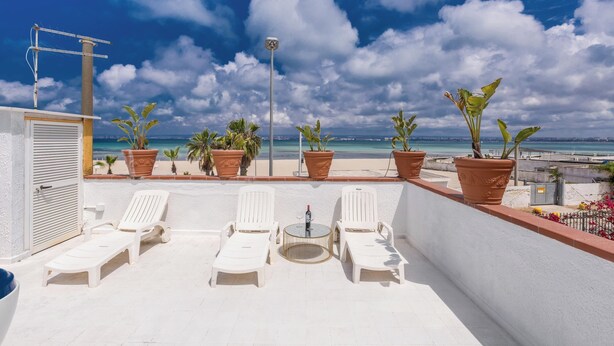 A rooftop terrace with white lounge chairs, a small round table, and potted plants. - 3997 Villa Thalissa by Barbarhouse (Taranto)