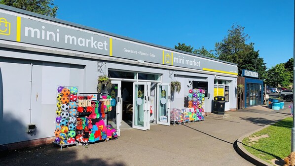 A mini market with a storefront displaying various colorful items. - Wl56 Haven Haggerston Castle Holiday Park (Berwick-upon-Tweed)