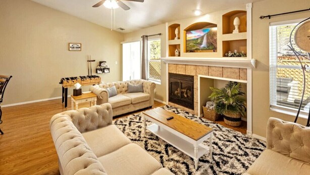A living room with a fireplace, a sofa set, a coffee table, and a ceiling fan. - Family Mountain Retreat ~Game Table ~Fire Table (Flagstaff)