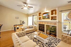 A living room with a fireplace, a sofa set, a coffee table, and a ceiling fan. - Family Mountain Retreat ~Game Table ~Fire Table (Flagstaff)