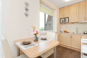 Appartement, 1 chambre, balcon | Cuisine privée | Micro-ondes, chaise haute, batterie de cuisine, vaisselle et ustensiles