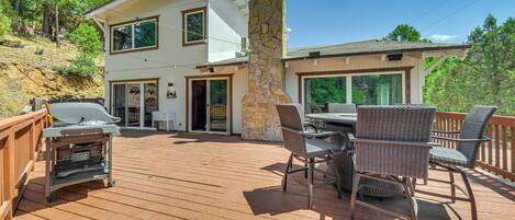Enjoy al fresco dining on the outdoor deck, complete with a grill and comfortable seating.