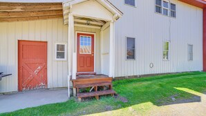 A two-story building with a red door and a small porch. - 10 Mi to Lake Superior: Eben Junction Townhome! (Eben Junction)