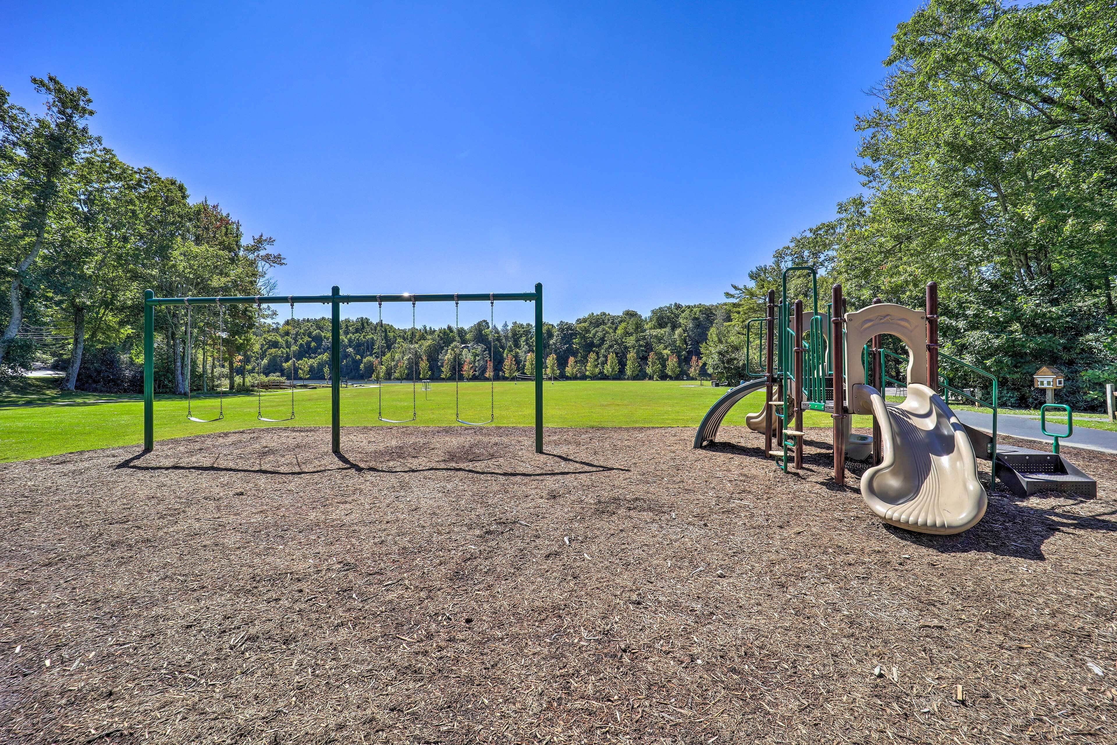 A playground with swings, a slide, and a climbing structure.