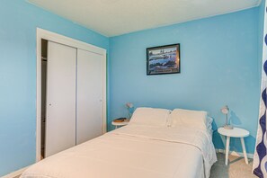 A bedroom with a bed, a nightstand, a framed picture on the wall, and a closet. - Family-friendly OKC Area Getaway: Dogs Welcome! (Bethany)