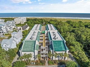 Experience the resort's tranquil courtyard, surrounded by lush greenery and a stunning beach.