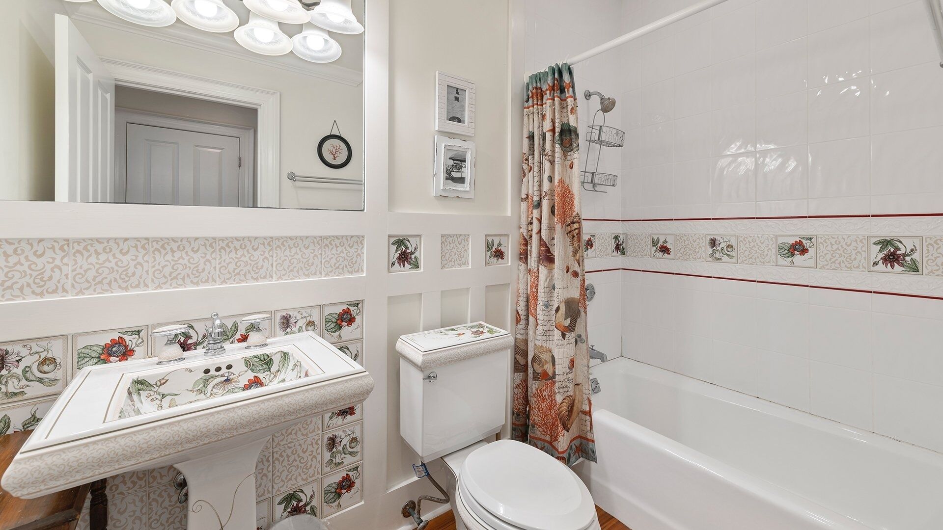 A bathroom with a toilet, sink, and bathtub.