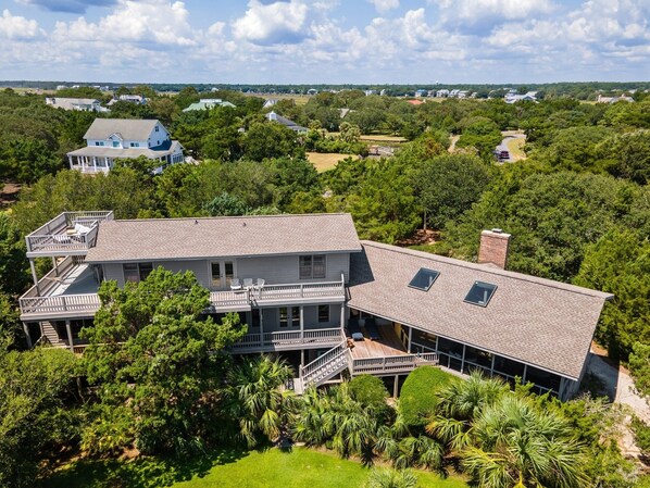 A large, two-story house with a spacious deck and multiple windows. - Natural And Serene Home Away From Home 5 Bedroom Home by Peace Vacations (Georgetown)