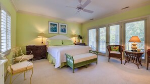 Relax in this serene bedroom with a large bed, nightstands, and a cozy reading area.
