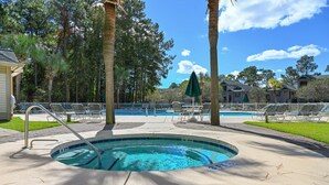 A swimming pool area with lounge chairs, palm trees, and a clear blue sky. - Welcome To True Blue 52 F 2 Bedroom Condo by Peace Vacations (Pawleys Island)