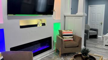 Smart TV, fireplace, books, computer monitors