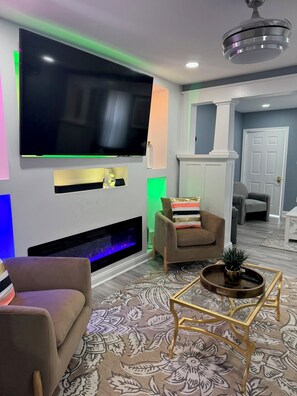 Smart TV, fireplace, books, computer monitors