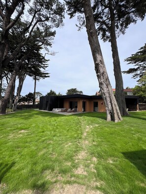 Enjoy a serene retreat in this contemporary home with a backyard and outdoor seating area.