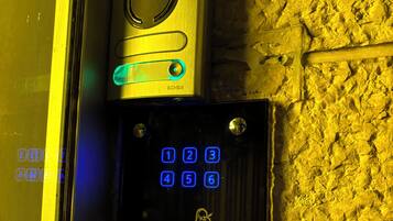 A keypad lock with a keyhole and a digital display.