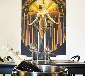 Savor fine dining in a stylish setting with a beautiful abstract art piece and elegant table setting.
