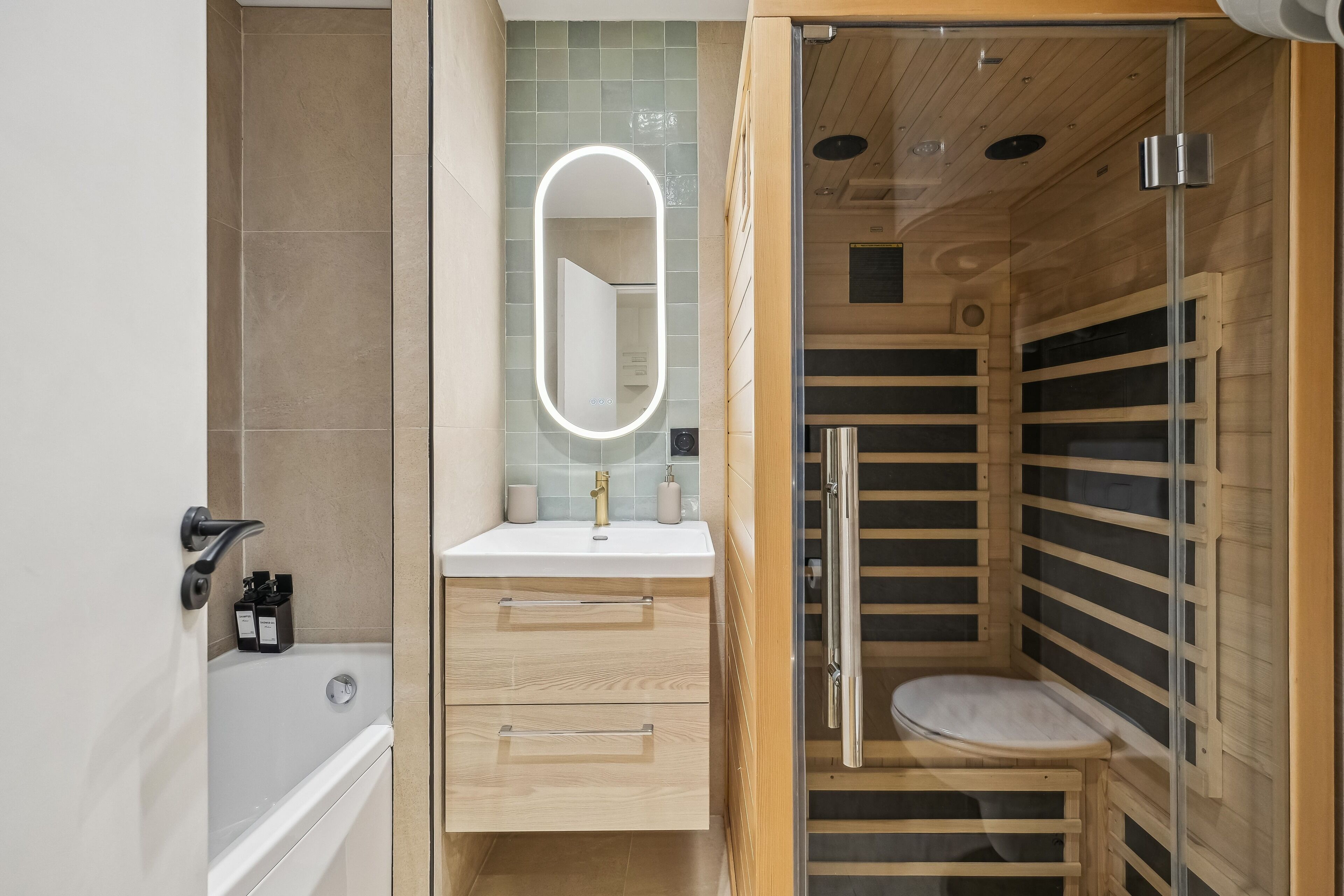 A modern bathroom with a bathtub, a vanity with a mirror, and a shower enclosure.