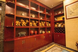 A room with a red wooden cabinet containing various items. - Dunhuang Tianqin Yunshui Hotel (Dunhuang)