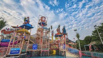 A water park with multiple slides and a pool area.