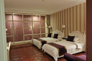 A hotel room with two beds, a large window, and a striped wall. - Xuzhou Amusement Land Resort Hotel (Xuzhou)