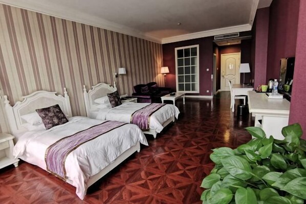 A hotel room with two beds, a desk, a chair, a mirror, and a large window. - Xuzhou Amusement Land Resort Hotel (Xuzhou)
