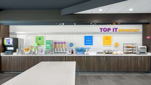 A breakfast counter with various food options and a sign reading "TOP IT BREAKFAST". - Tru by Hilton Norco Eastvale (Norco)