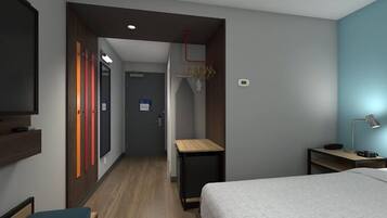 Une chambre d’hôtel comprenant un lit, un bureau, une télévision, une armoire et une salle de bain.