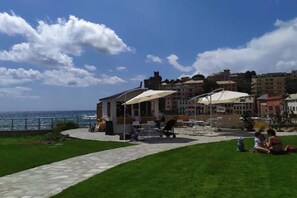 Guests can enjoy a tranquil outdoor seating area overlooking the coastal promenade.