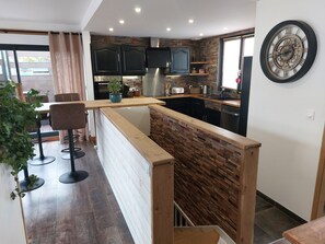 Enjoy cooking in this well-equipped kitchen with a refrigerator, oven, and sink.